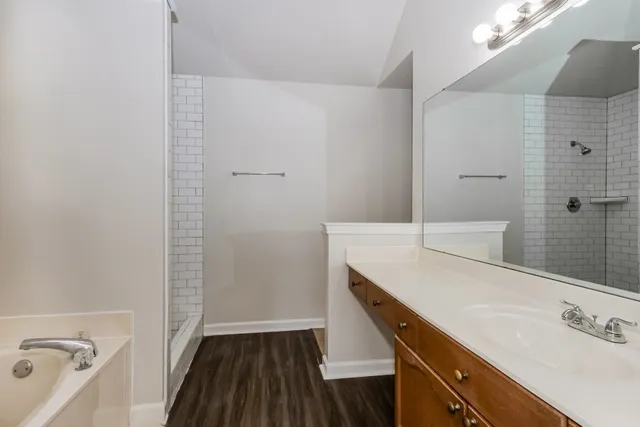 a bathroom with a granite countertop sink a toilet and shower