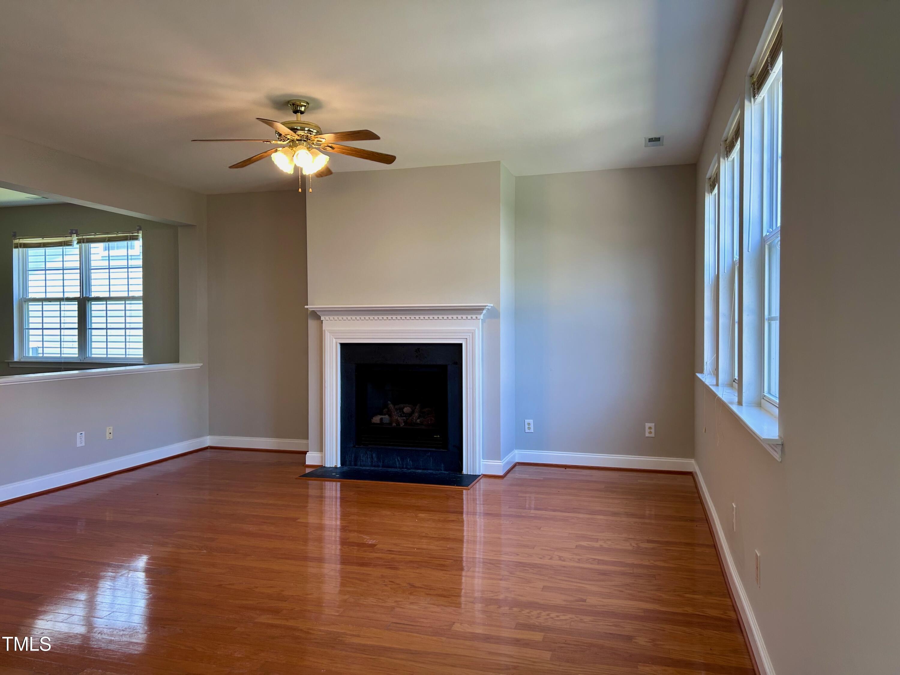 4029 Wester Road Raleigh, NC 27604 - Photo 11 of 37 a view of an empty room with wooden floor and a window