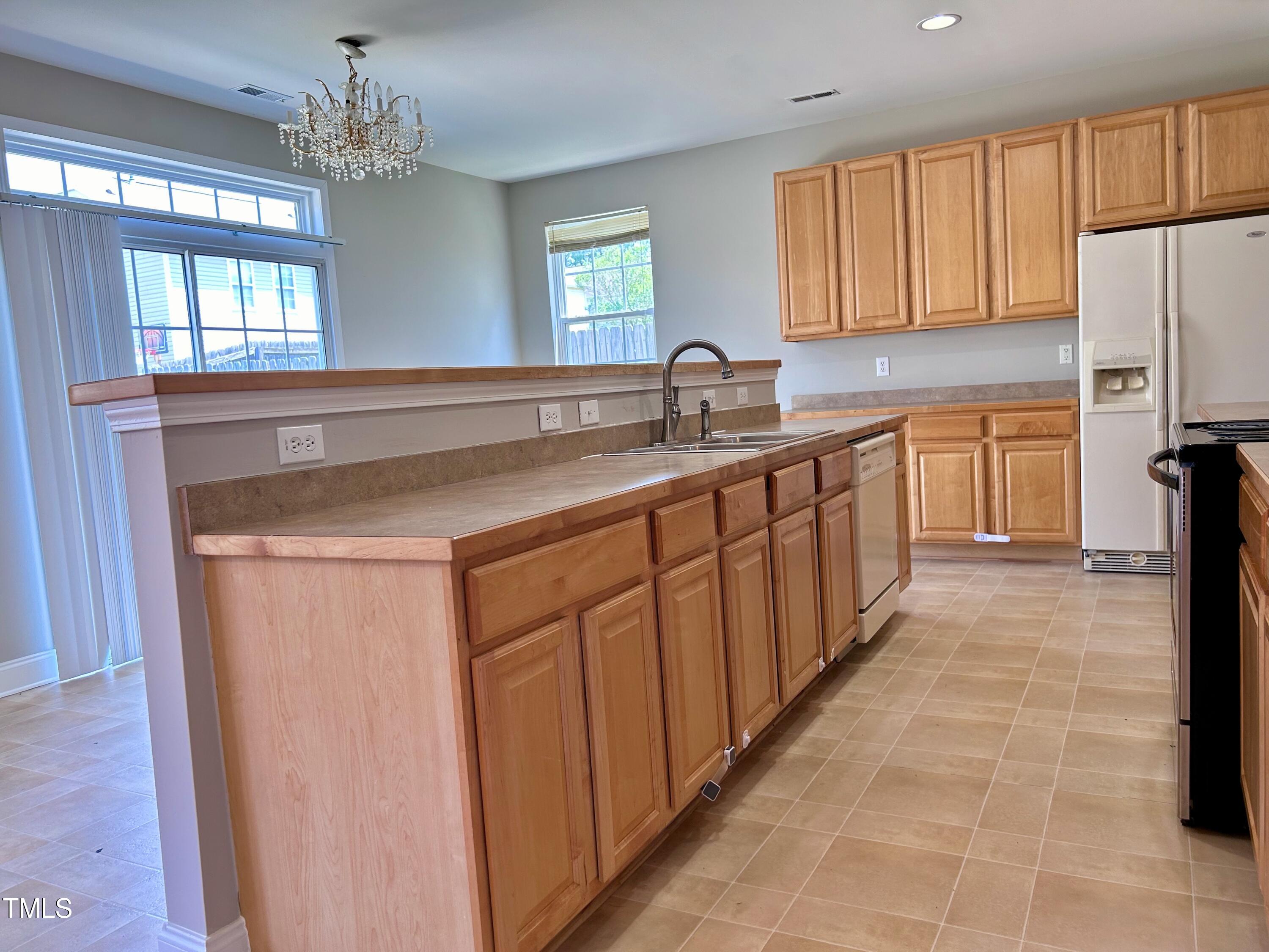 4029 Wester Road Raleigh, NC 27604 - Photo 17 of 37 a kitchen with stainless steel appliances a sink stove and cabinets