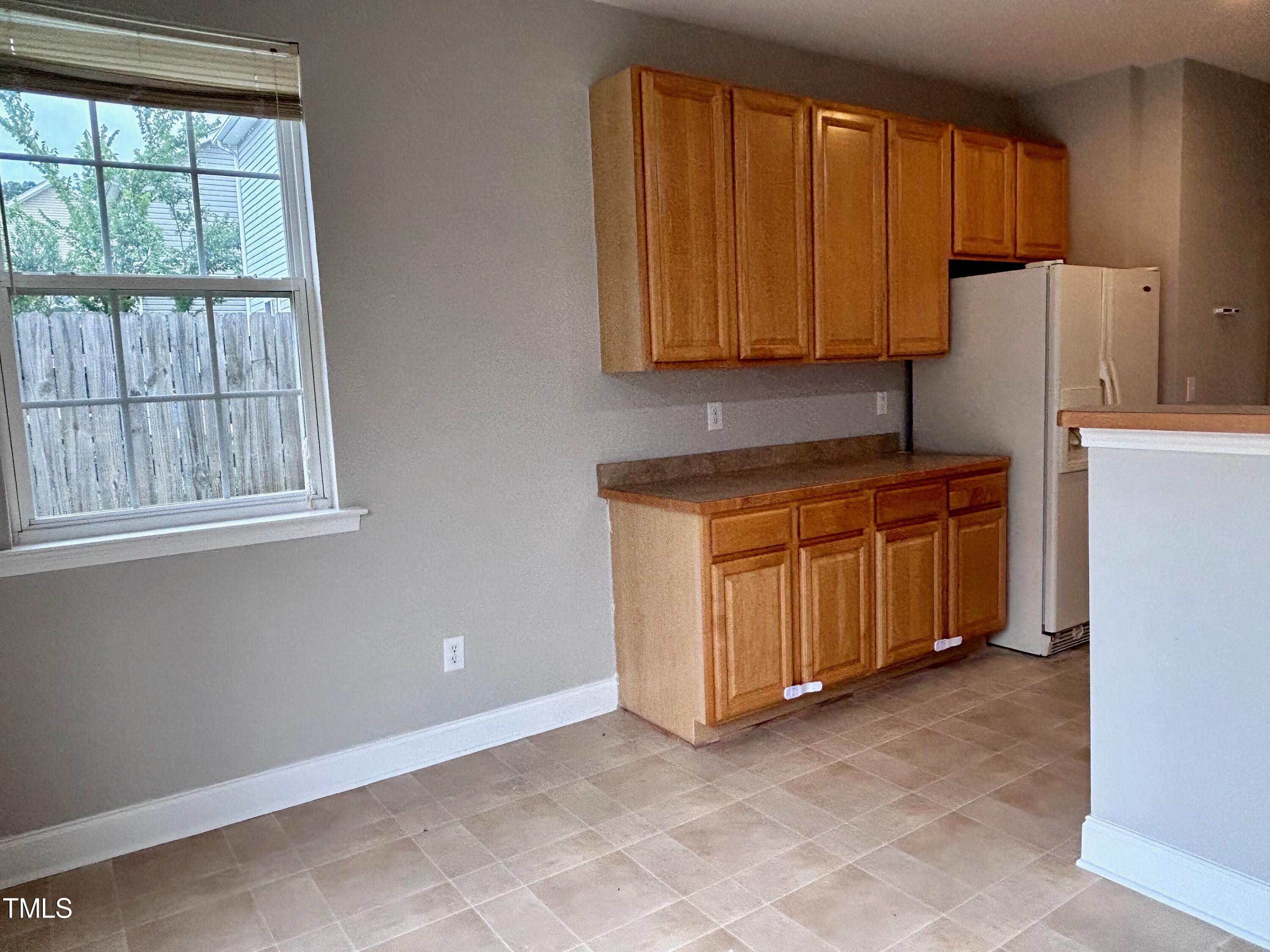 4029 Wester Road Raleigh, NC 27604 - Photo 18 of 37 a room with a refrigerator and a sink