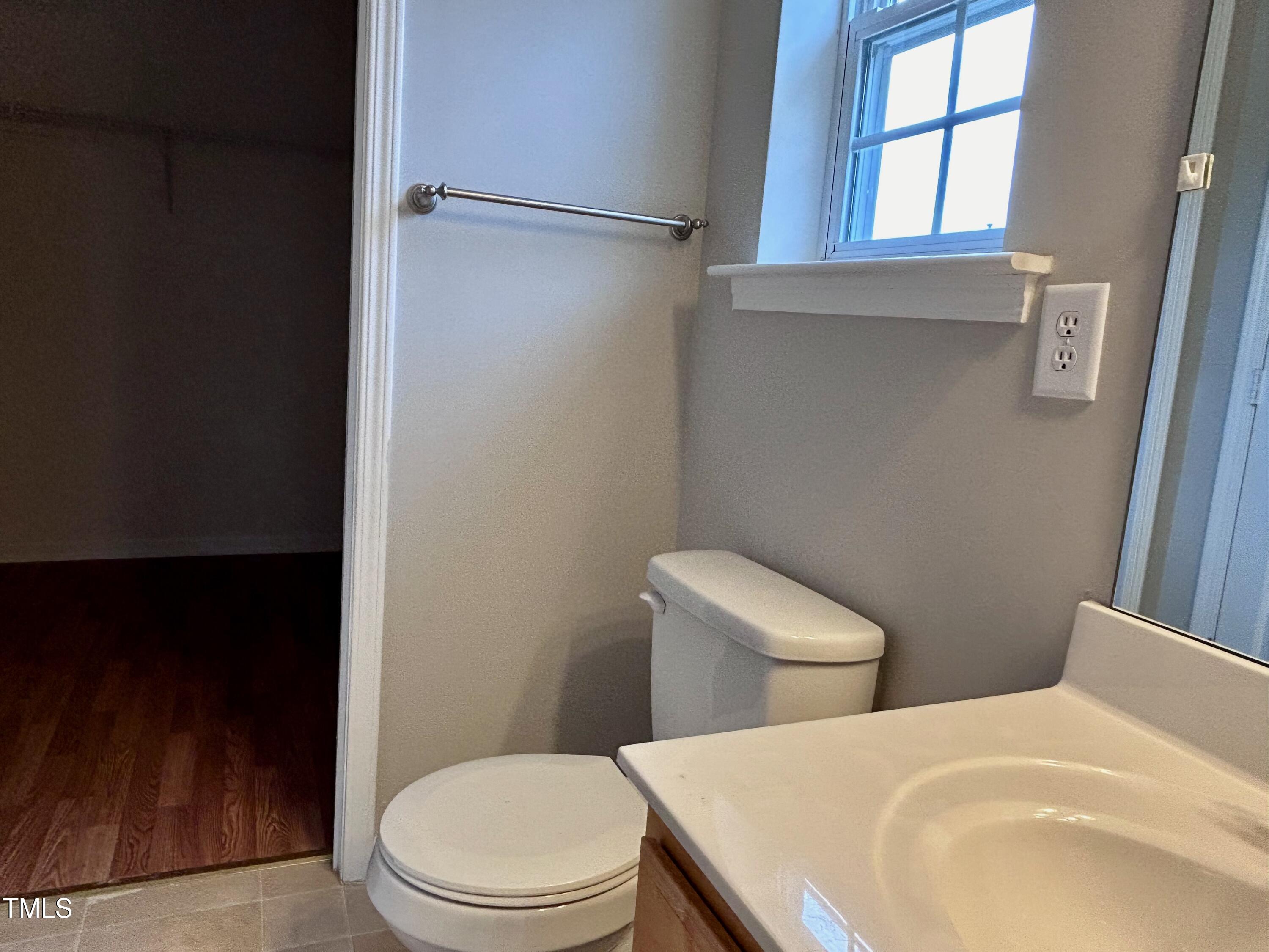 4029 Wester Road Raleigh, NC 27604 - Photo 31 of 37 a white toilet sitting next to a bathroom sink