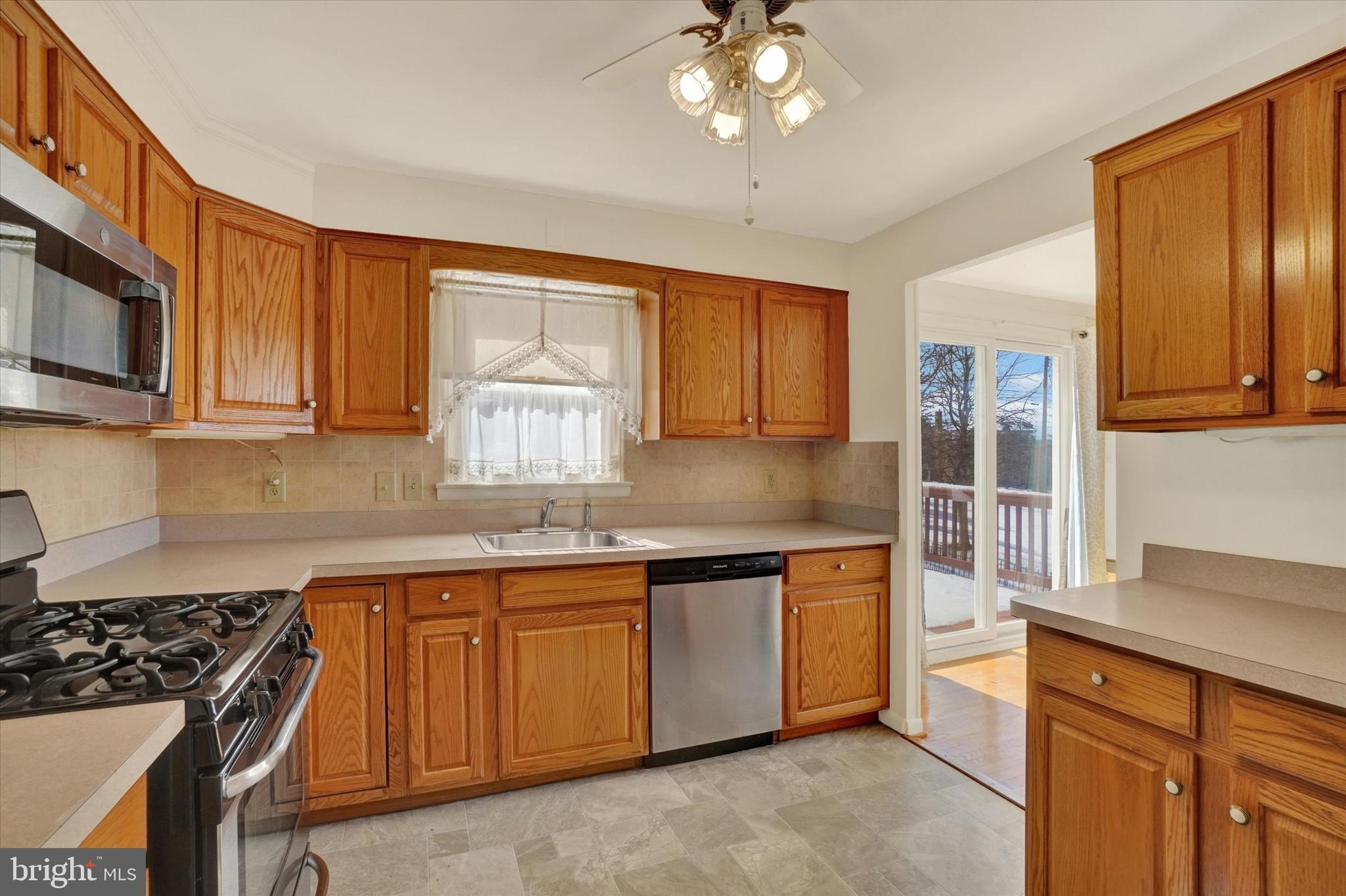 2670 Raleigh Drive York, PA 17402 - Photo 16 of 33 a kitchen with stainless steel appliances granite countertop a sink a stove cabinets and wooden floor