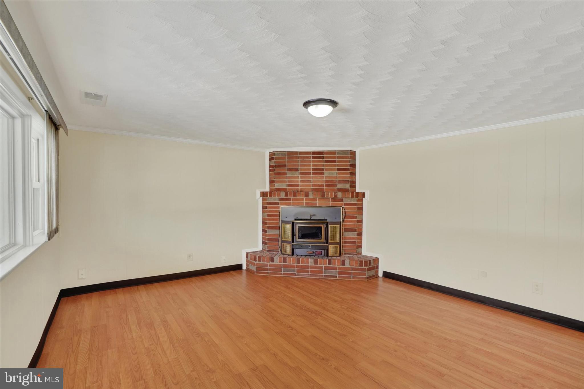 2670 Raleigh Drive York, PA 17402 - Photo 4 of 33 a view of empty room with wooden floor and fireplace