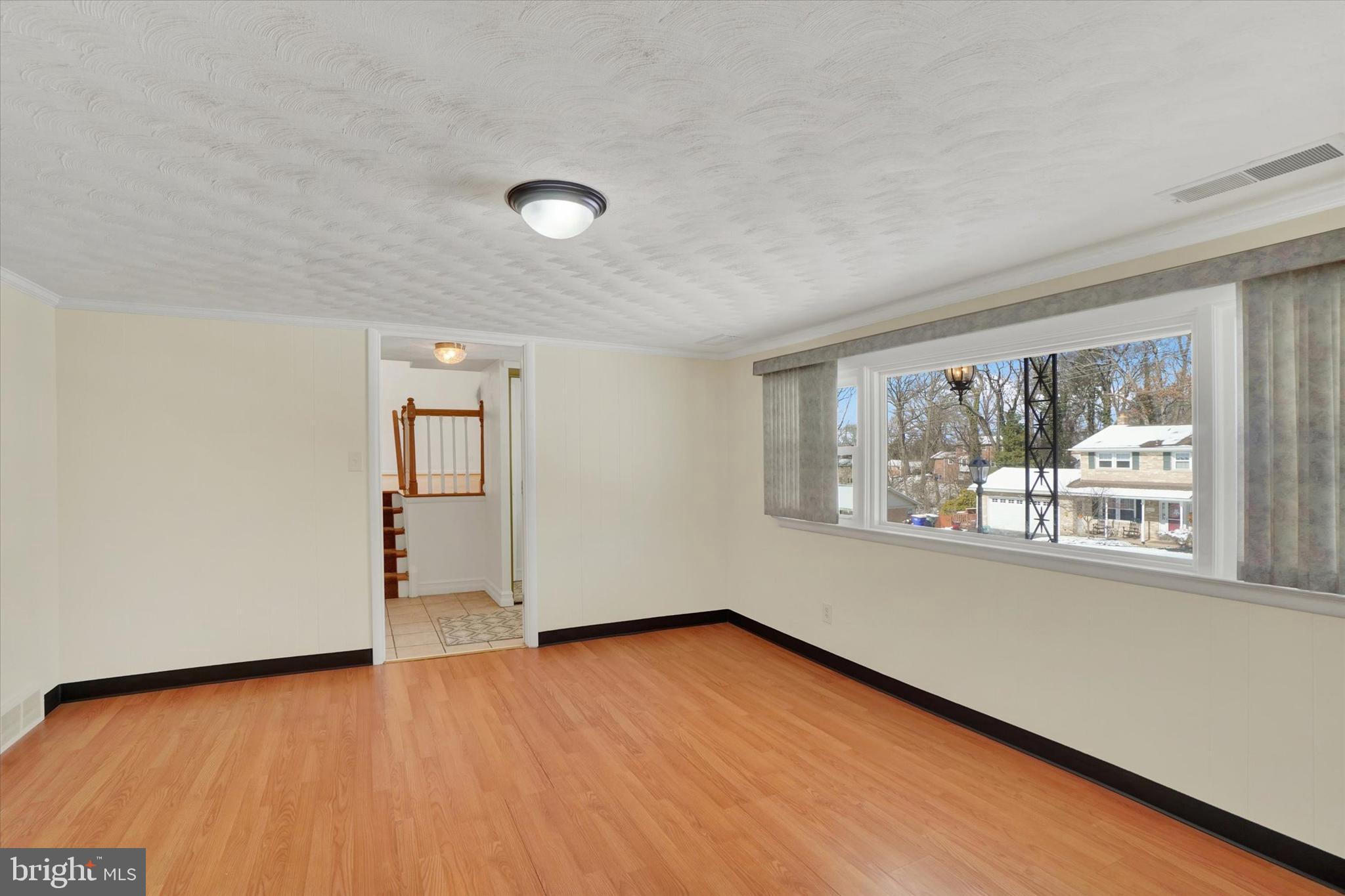 2670 Raleigh Drive York, PA 17402 - Photo 5 of 33 an empty room with wooden floor and windows