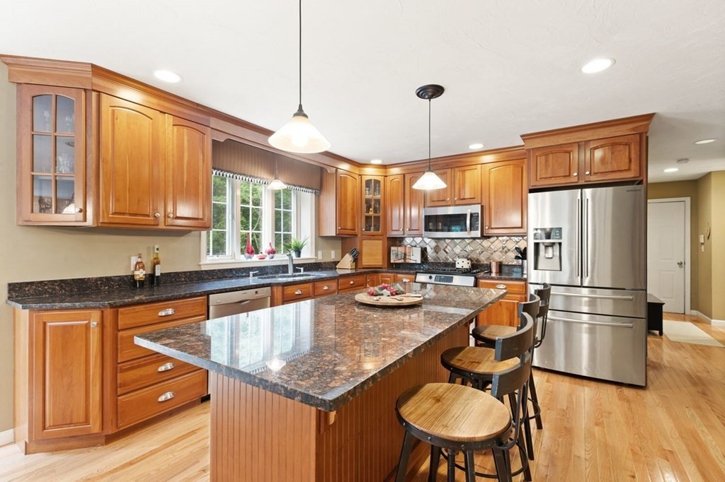 3 Symphony Drive Easton, MA 02356 - Photo 15 of 42 a kitchen with stainless steel appliances granite countertop a sink a stove a refrigerator cabinets and chairs