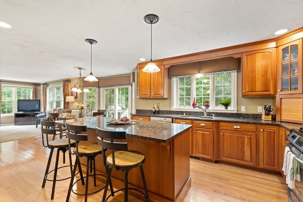 3 Symphony Drive Easton, MA 02356 - Photo 18 of 42 a dining hall with stainless steel appliances granite countertop wooden floor and a view of living room