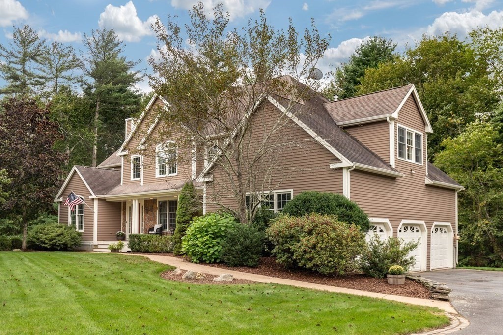 3 Symphony Drive Easton, MA 02356 - Photo 2 of 42 a front view of a house with a garden and plants