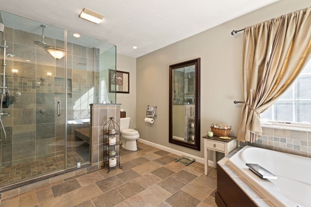 3 Symphony Drive Easton, MA 02356 - Photo 28 of 42 a bathroom with a tub a sink and a large mirror next to a window