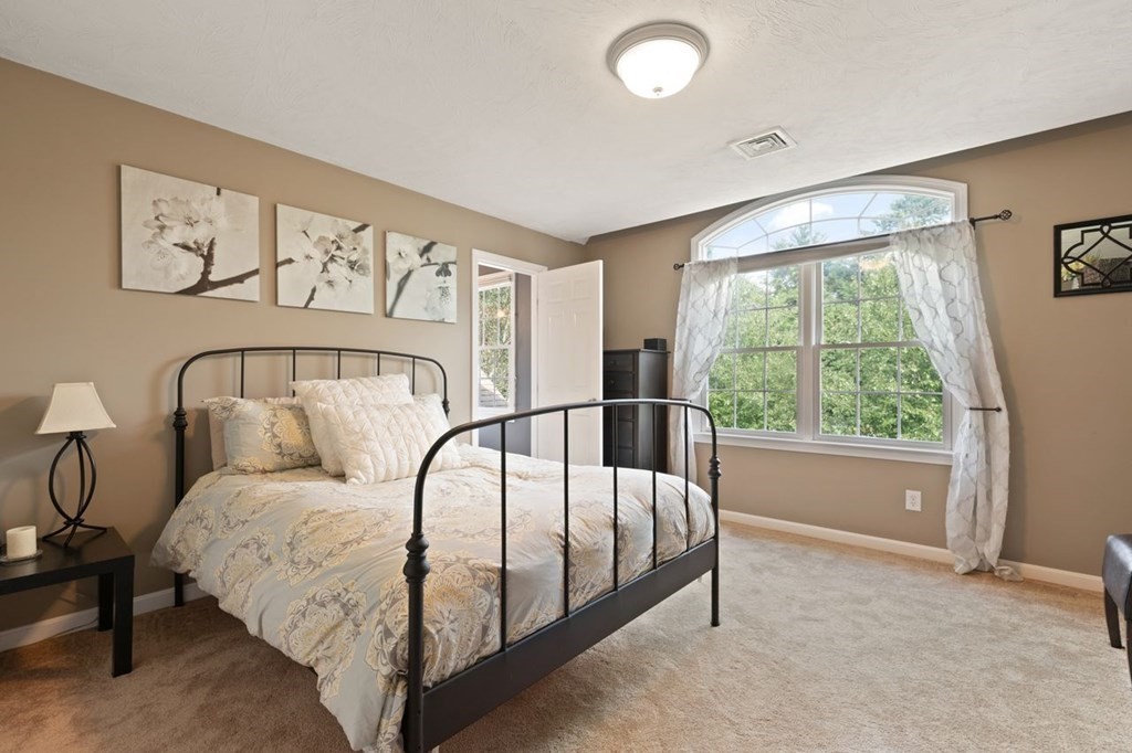 3 Symphony Drive Easton, MA 02356 - Photo 29 of 42 a large white bed sitting in a room next to a window