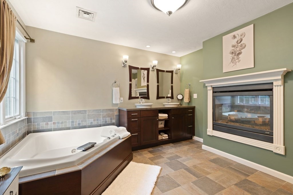 3 Symphony Drive Easton, MA 02356 - Photo 32 of 42 a bathroom with a tub a double vanity sink and mirror