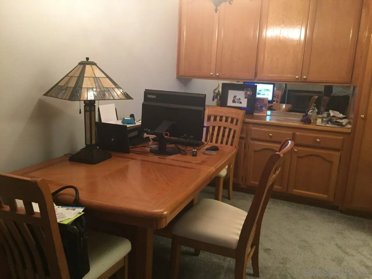 5845 Friars Road, Unit 1206 San Diego, CA 92110 - Photo 3 of 9 a kitchen with a table chairs and a refrigerator