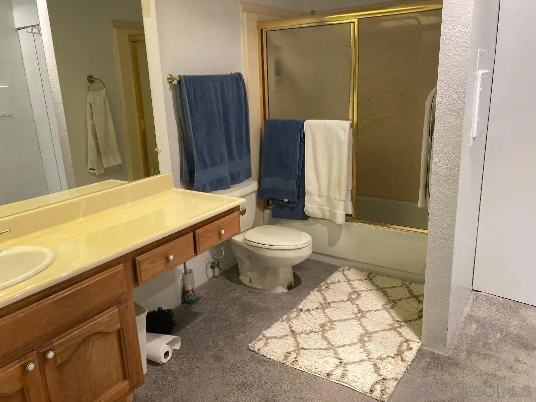 5845 Friars Road, Unit 1206 San Diego, CA 92110 - Photo 6 of 9 a bathroom with a sink toilet and shower