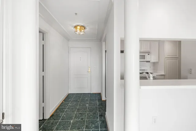 a view of hallway with wooden floor