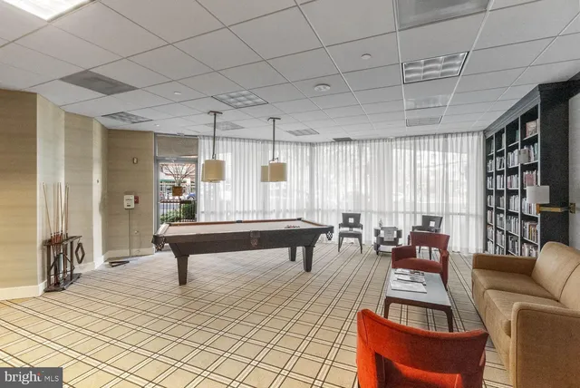 a living room with furniture a table and a potted plant