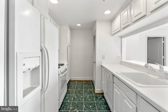 a bathroom with a sink a toilet a mirror and shower