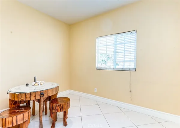 a view of a room with a table and chairs