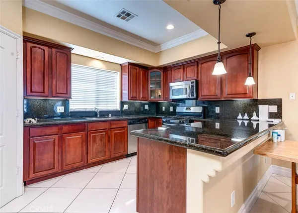 a kitchen with stainless steel appliances granite countertop a stove sink and cabinets