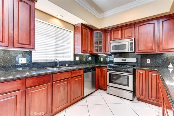 a kitchen with stainless steel appliances granite countertop a stove sink and cabinets