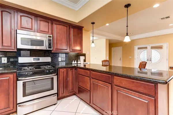 a kitchen with granite countertop cabinets stainless steel appliances and a sink