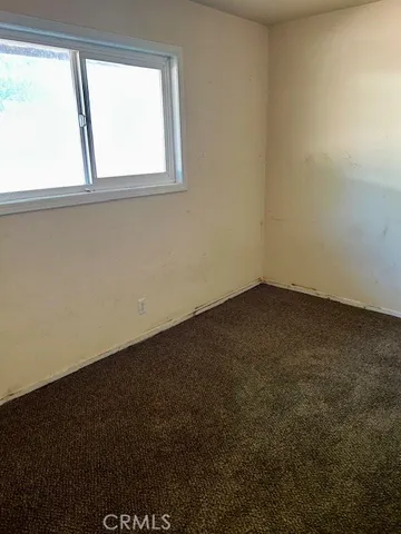 a view of an empty room with a fireplace