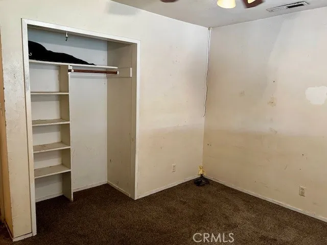 a bathroom with a granite countertop toilet and a sink