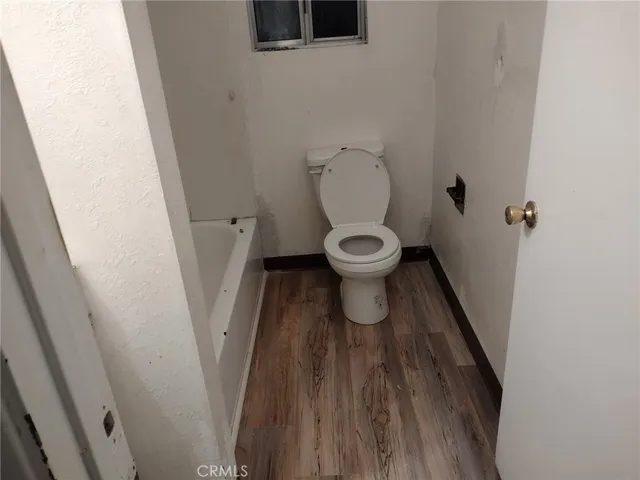 a backyard of a house with table and chairs a barbeque