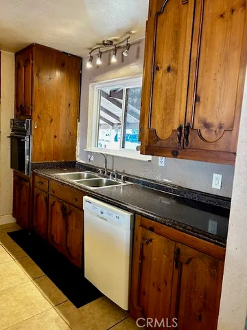 a kitchen with granite countertop a refrigerator and a stove