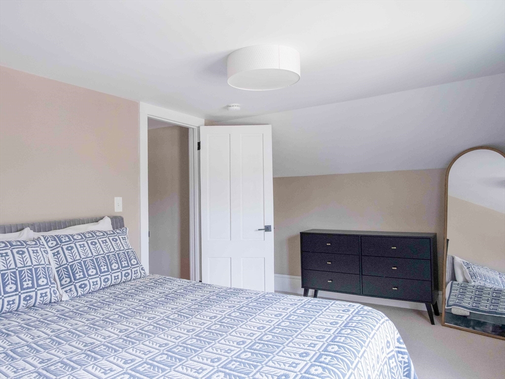 149 High Street, Unit 3 Danvers, MA 01923 - Photo 12 of 19 a bedroom with a bed and a dresser