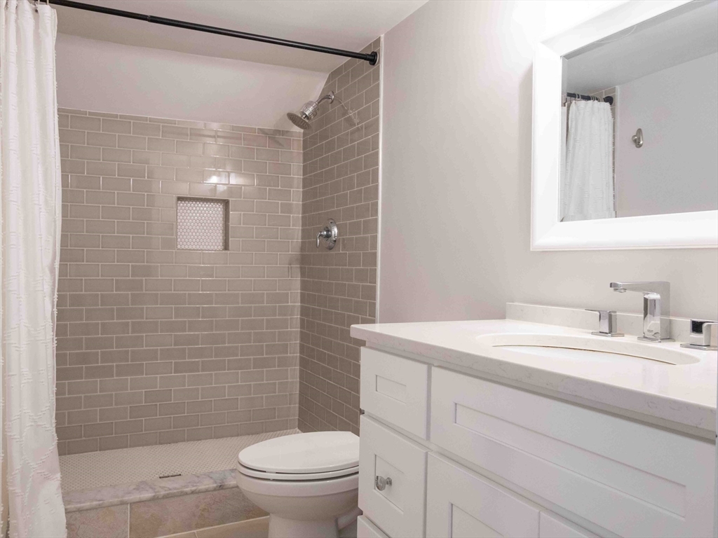 149 High Street, Unit 3 Danvers, MA 01923 - Photo 14 of 19 a bathroom with a sink a toilet and shower