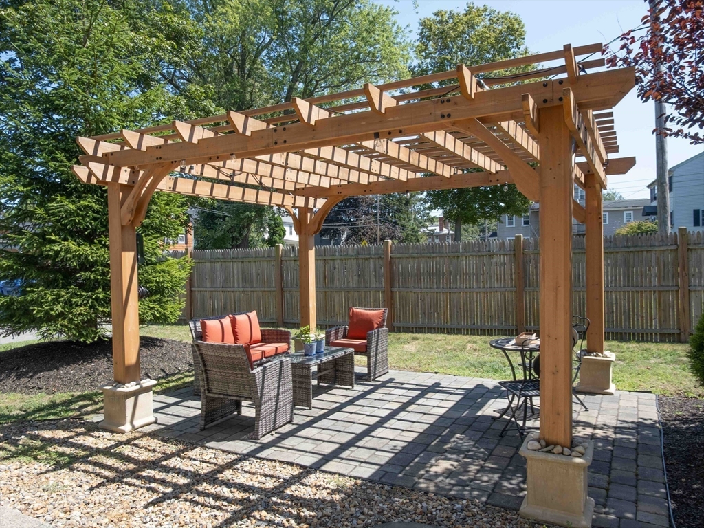149 High Street, Unit 3 Danvers, MA 01923 - Photo 18 of 19 a view of a chairs and tables in the back yard of a house