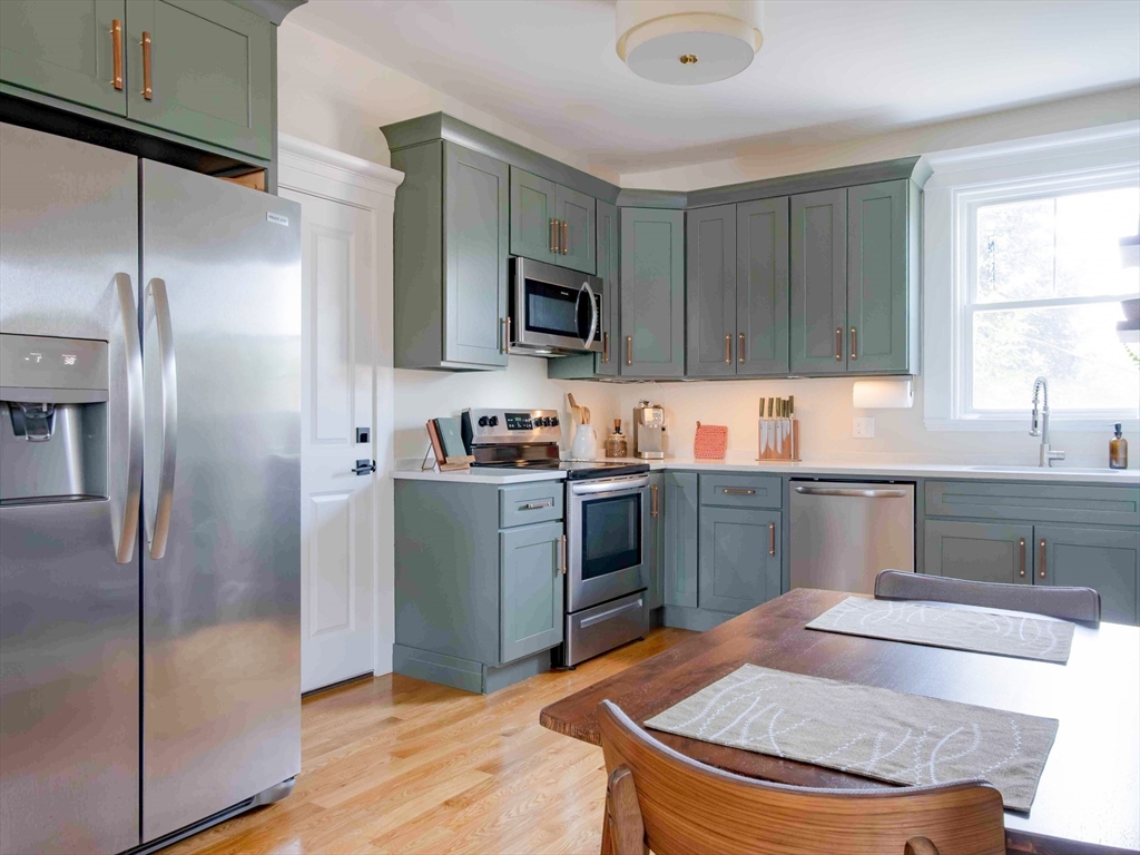 149 High Street, Unit 3 Danvers, MA 01923 - Photo 2 of 19 a kitchen with stainless steel appliances granite countertop a refrigerator a sink a stove a microwave and island