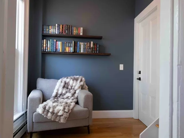 a living room with furniture and a book shelf