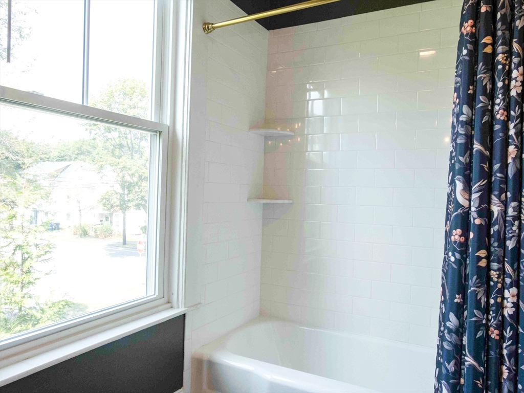 149 High Street, Unit 3 Danvers, MA 01923 - Photo 9 of 19 a bathroom with a bathtub and shower