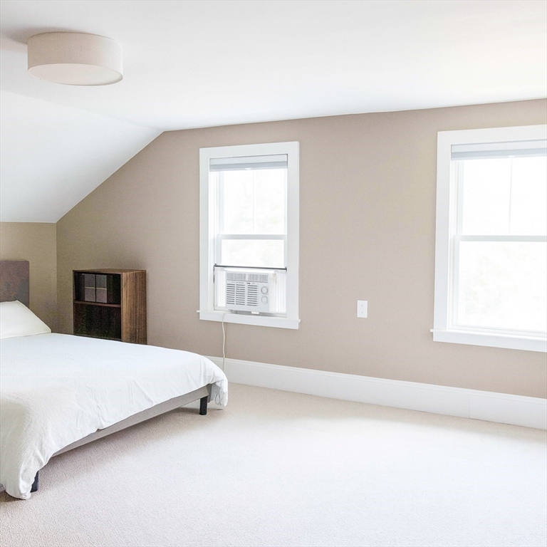 149 High Street, Unit 3 Danvers, MA 01923 - Photo 10 of 19 a bedroom with a bed and a window