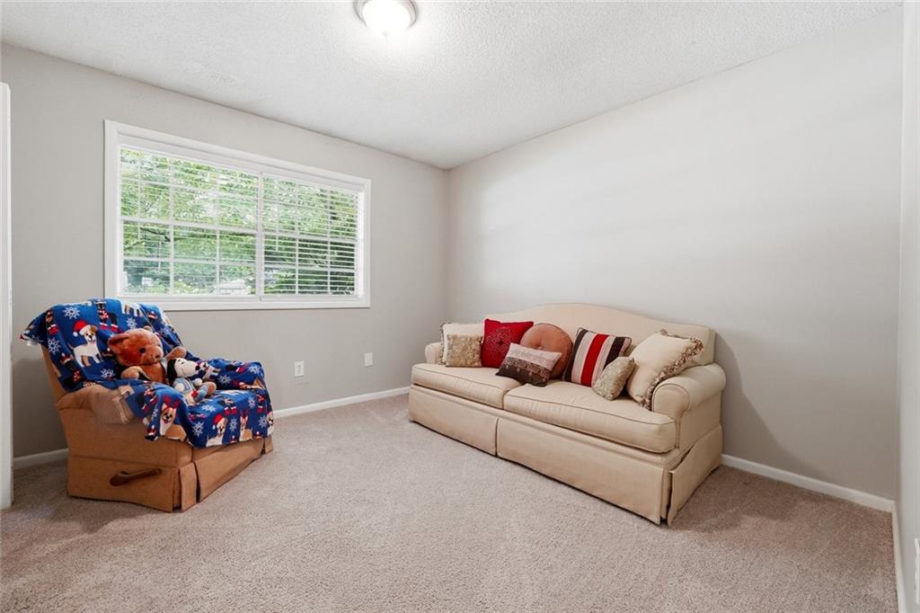 1619 Ridgeview Drive Northwest Conyers, GA 30012 - Photo 16 of 20 a living room with furniture and a window
