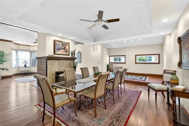 a dining room with furniture a rug and wooden floor