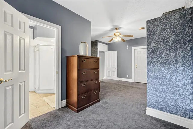a view of a hallway with closet and cabinet