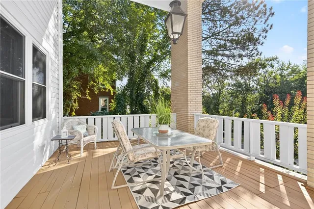 a view of balcony with wooden floor and outdoor seating