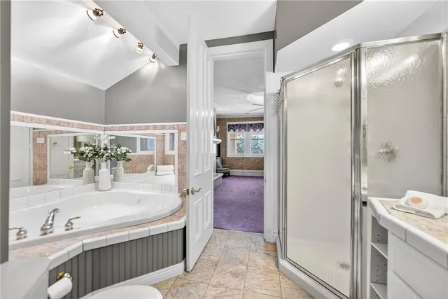 a bathroom with a tub sink and mirror