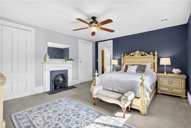 a bedroom with a bed and a ceiling fan