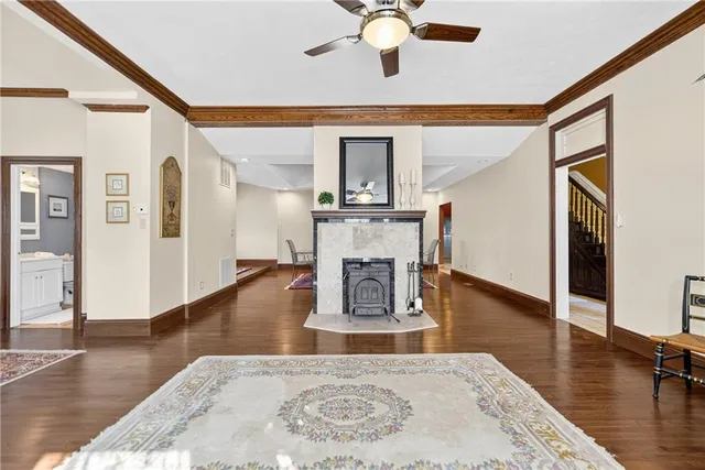 a living room with fireplace furniture and a wooden floor