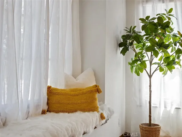 a bed sitting in a bedroom next to a window