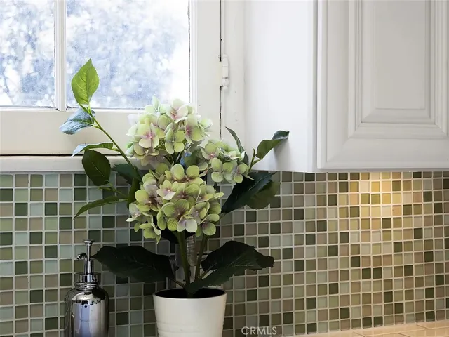 a vase of flowers sitting on a bathroom sink