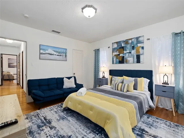 a bedroom with a bed and couch