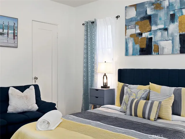 a bedroom with a bed and window