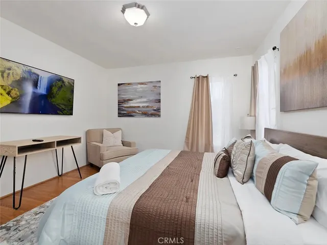 a bedroom with a bed and a desk