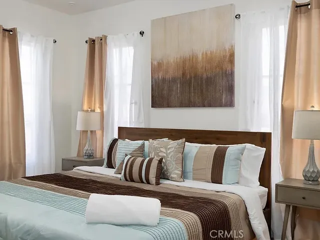 a bed sitting in a bedroom next to a window