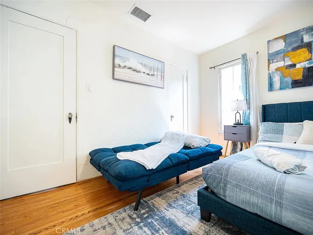 a bedroom with two beds and painting on the wall