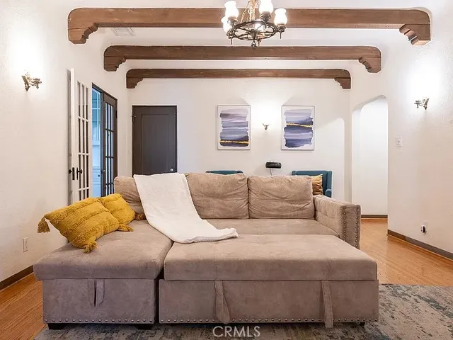 a bedroom with a large bed and a chandelier