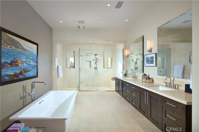 a bathroom with a toilet a sink a mirror a vanity and shower